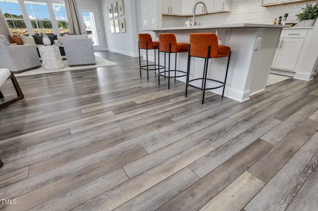 a living room with furniture wooden floor and a table