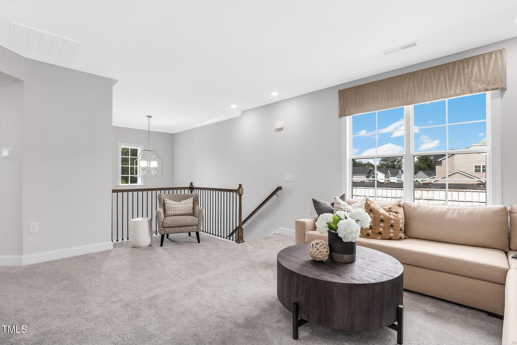 329 Calvander Lane Apex, NC 27539 - Photo 25 of 47 a living room with furniture and a potted plant
