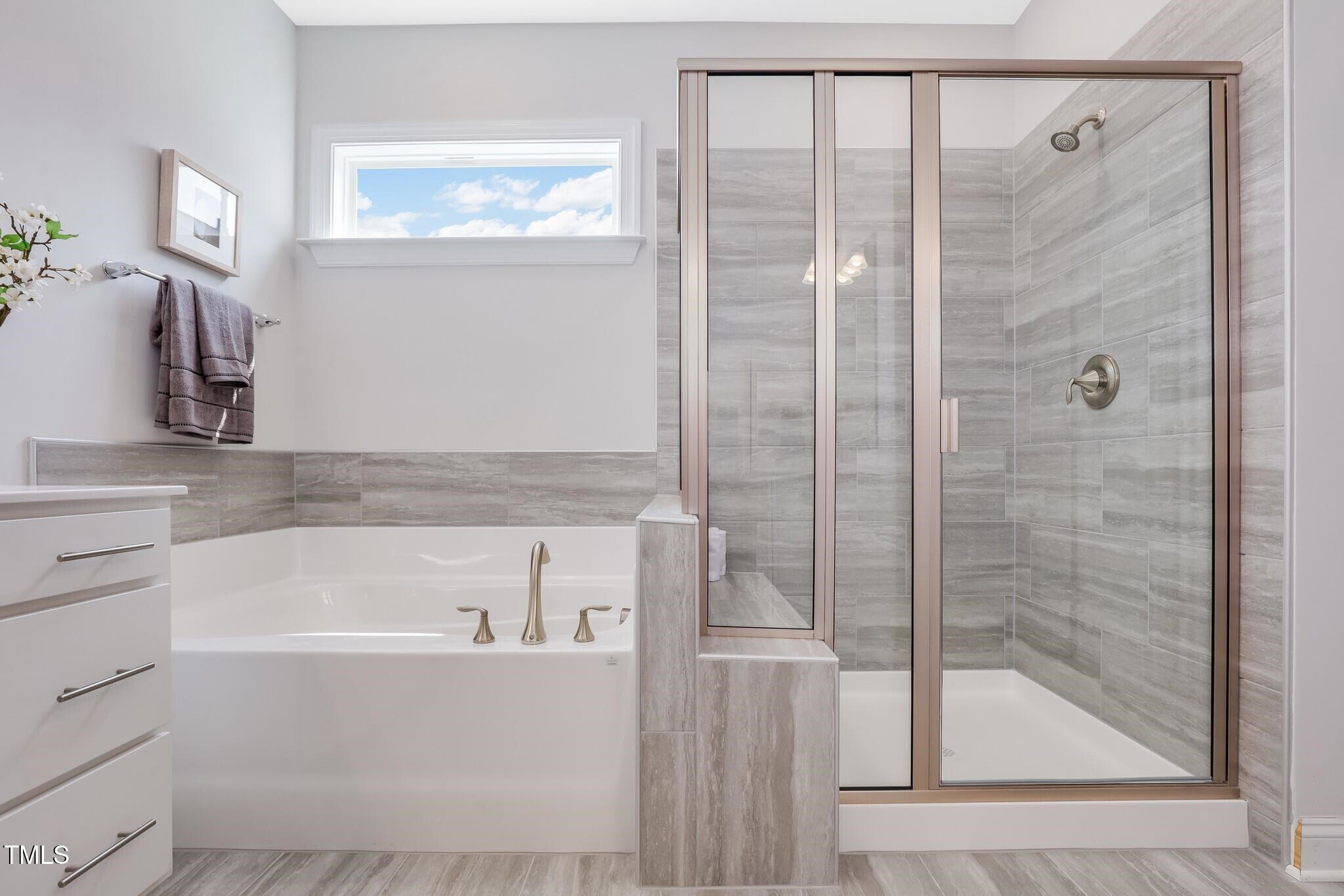329 Calvander Lane Apex, NC 27539 - Photo 30 of 47 a bathroom with a bathtub and a shower
