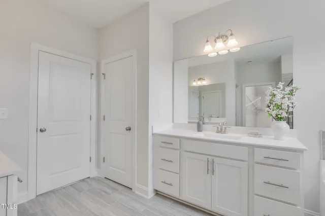 a bathroom with a double vanity sink and mirror