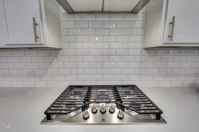 a stove top oven sitting inside of a kitchen