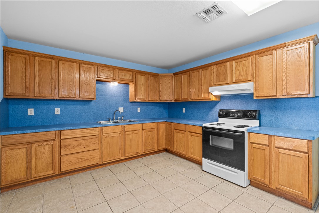 636 South County Road 1150 Riviera, TX 78379 - Photo 7 of 20 a kitchen with granite countertop cabinets stainless steel appliances and a sink