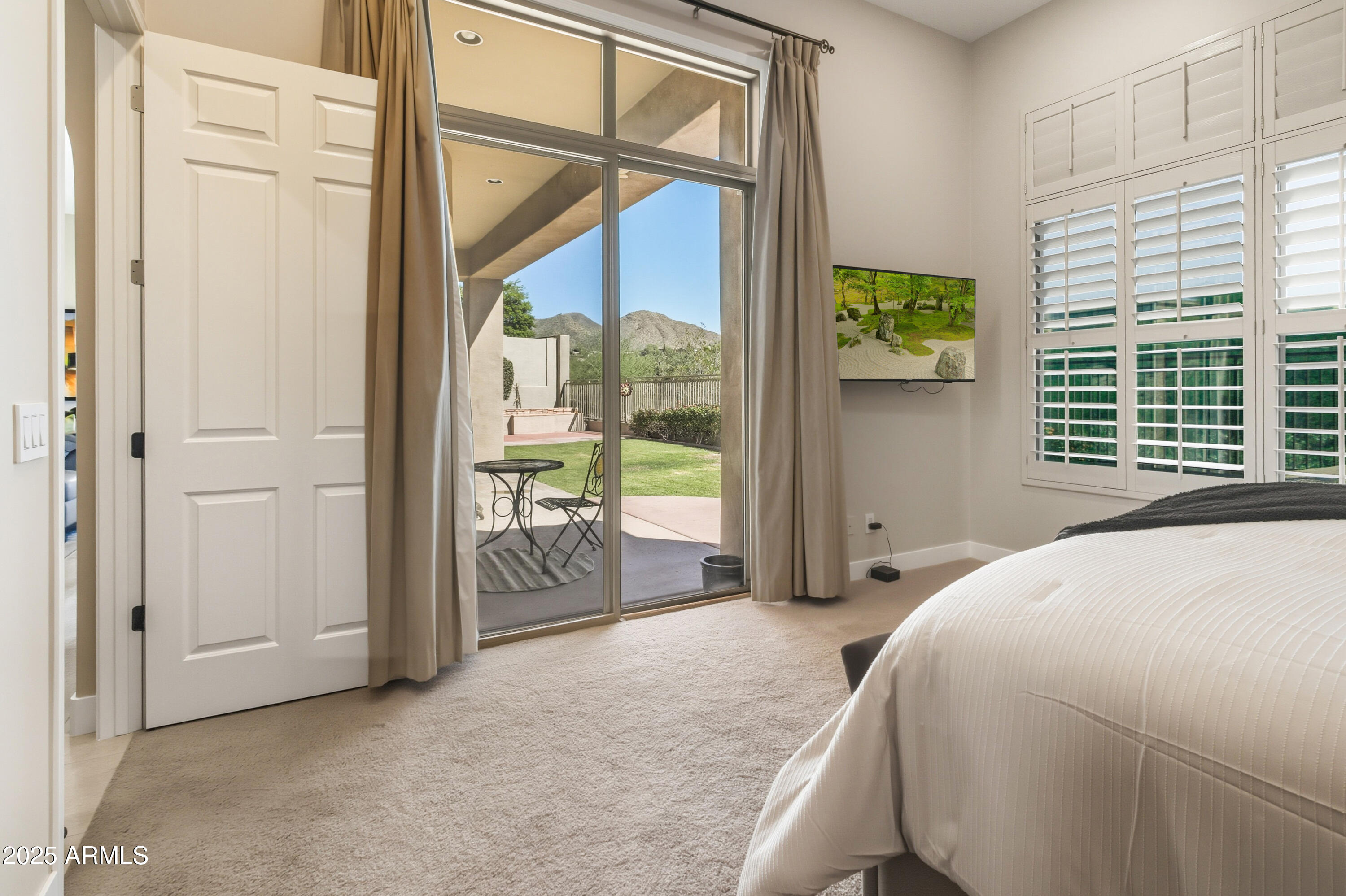 10637 East Blanche Drive Scottsdale, AZ 85255 - Photo 29 of 36 a spacious bedroom with a large bed and a window