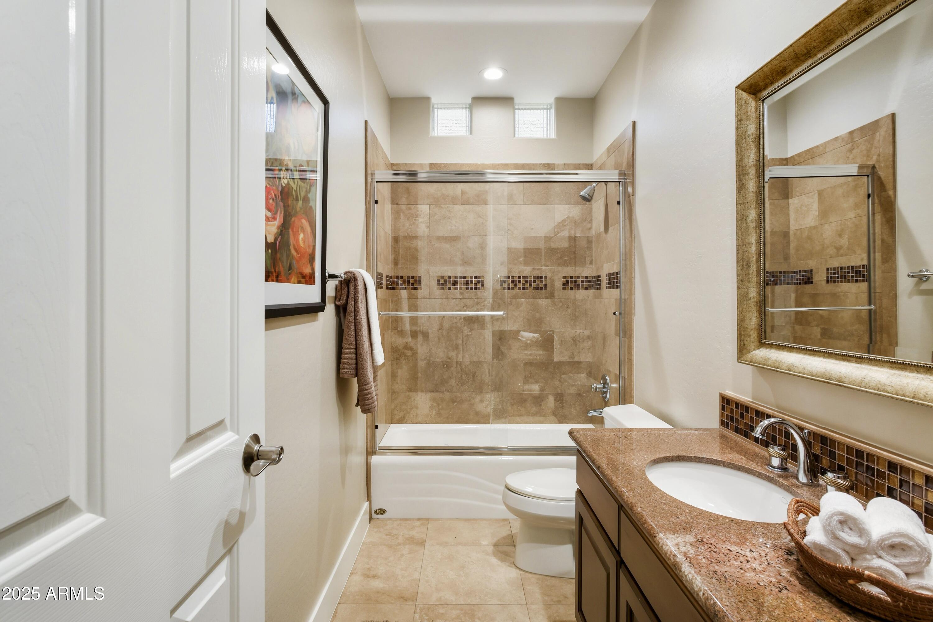 10637 East Blanche Drive Scottsdale, AZ 85255 - Photo 31 of 36 a bathroom with a granite countertop sink mirror bathtub and toilet