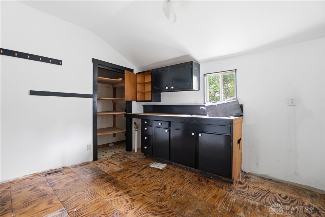 517 Broadway Street, Unit 515 Springfield, OH 45504 - Photo 10 of 29 This kitchen space offers ample storage with built-in cabinetry and open shelving, ready for your personal touch.