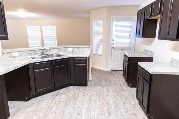 a kitchen with a sink and wooden cabinets