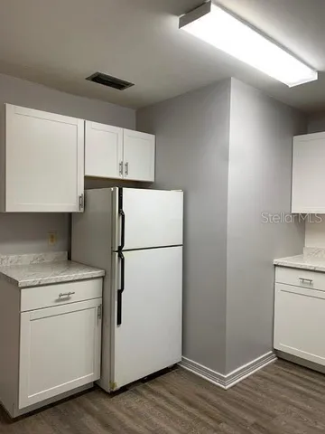 a white refrigerator freezer sitting inside of a kitchen