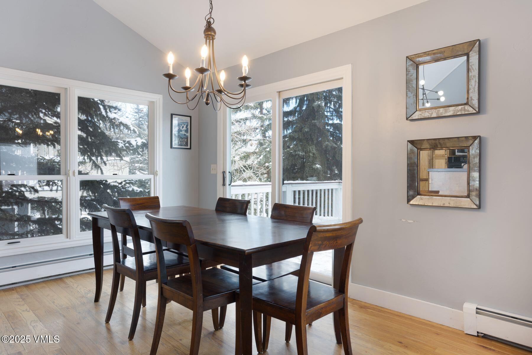 1289 Deer Boulevard, Unit A Eagle-Vail, CO 81620 - Photo 12 of 47 a view of a dining room with furniture a chandelier and wooden floor