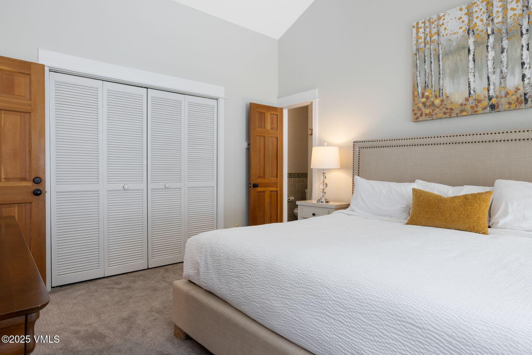 1289 Deer Boulevard, Unit A Eagle-Vail, CO 81620 - Photo 19 of 47 a bedroom with a bed and a painting on the wall