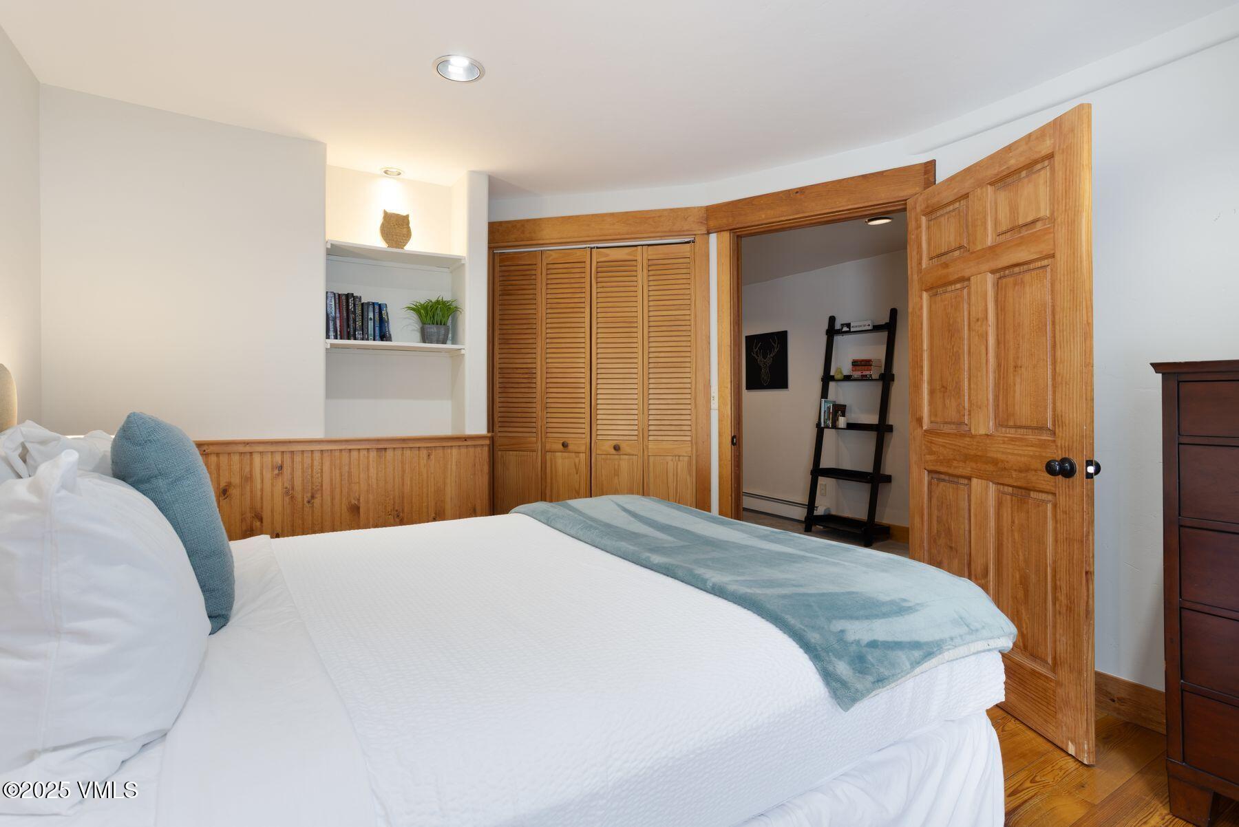 1289 Deer Boulevard, Unit A Eagle-Vail, CO 81620 - Photo 30 of 47 a bedroom with a bed and a mirror