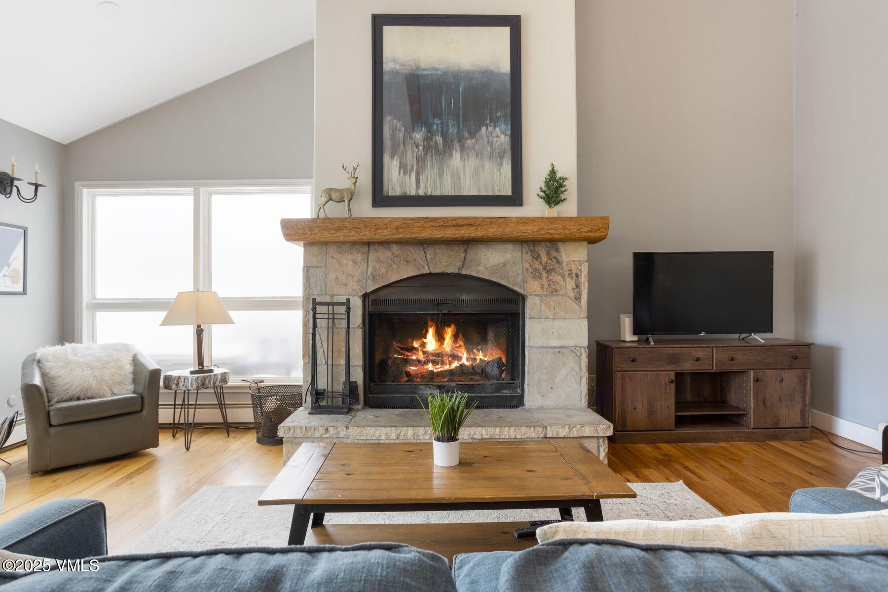 1289 Deer Boulevard, Unit A Eagle-Vail, CO 81620 - Photo 5 of 47 a living room with furniture and a fireplace