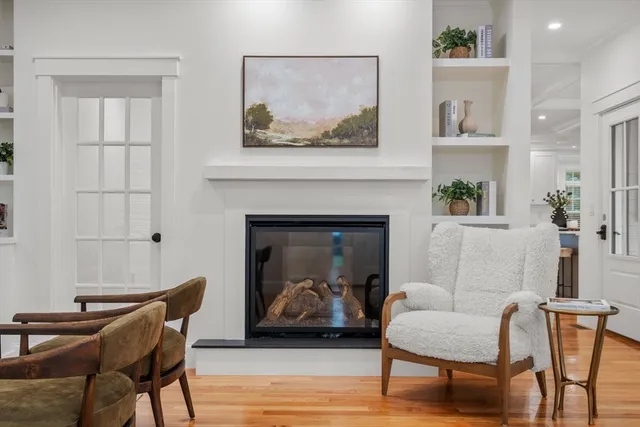 a living room with furniture a flat screen tv and a large window