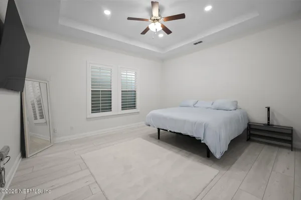 a bedroom with a bed and a ceiling fan