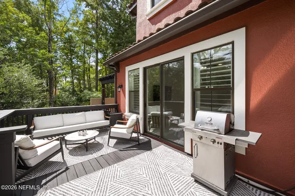 a front view of a house with swimming pool and furniture