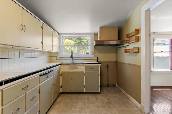 a kitchen with stainless steel appliances granite countertop a refrigerator sink and cabinets
