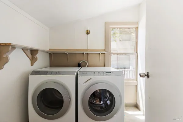 a view of a hallway with washer and dryer