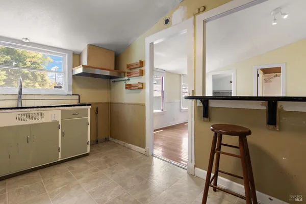 a kitchen with a refrigerator a sink and cabinets