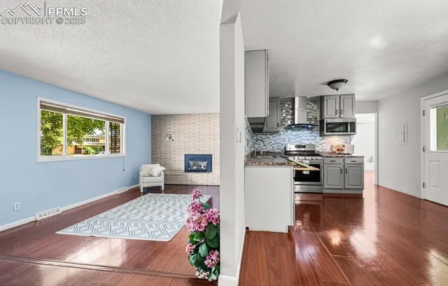 a kitchen with stainless steel appliances kitchen island granite countertop a refrigerator sink and stove