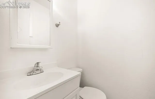 a bathroom with a sink a toilet and mirror