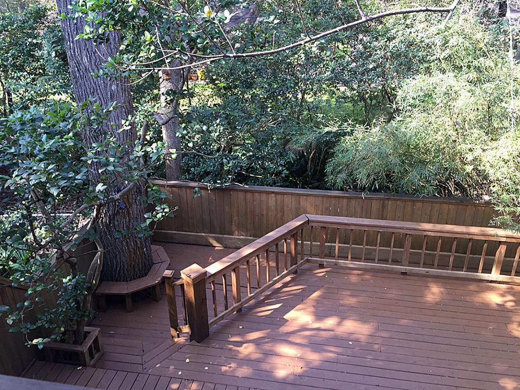 a view of balcony with wooden floor and outdoor seating