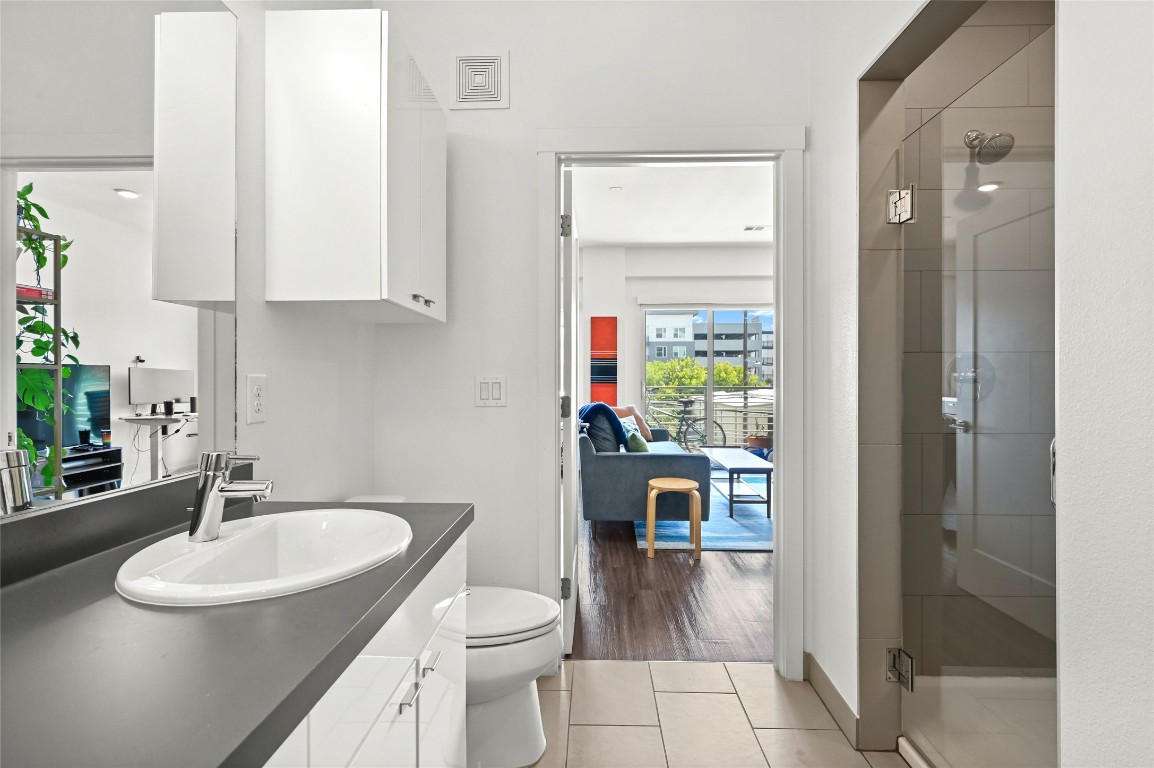 4361 South Congress Avenue, Unit 228 Austin, TX 78745 - Photo 13 of 20 a bathroom with a sink toilet and shower
