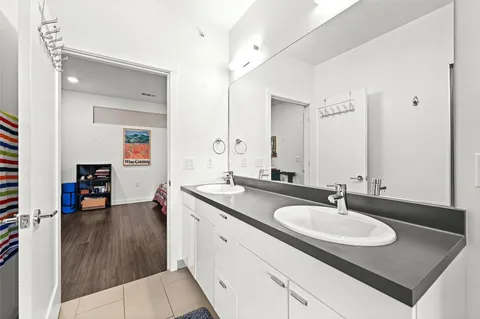 a bathroom with a sink double vanity and a mirror