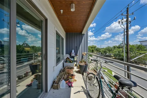 a view of a porch with furniture and floor to ceiling window