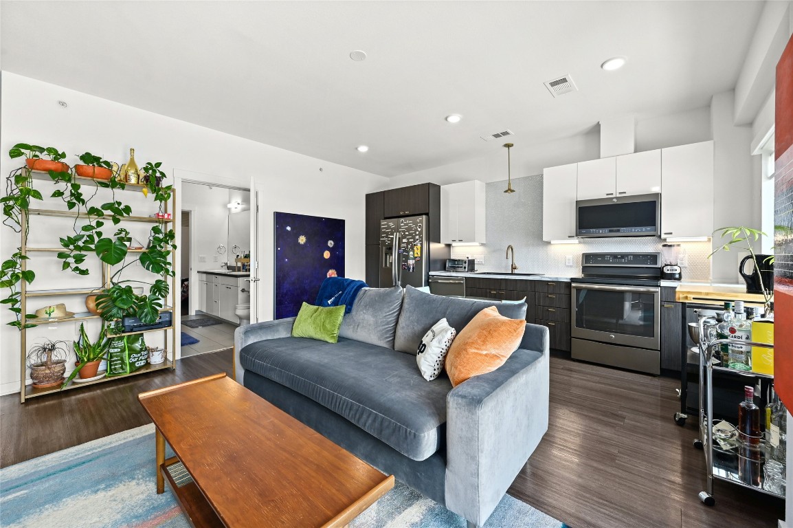 4361 South Congress Avenue, Unit 228 Austin, TX 78745 - Photo 2 of 20 a living room with stainless steel appliances furniture and a kitchen view