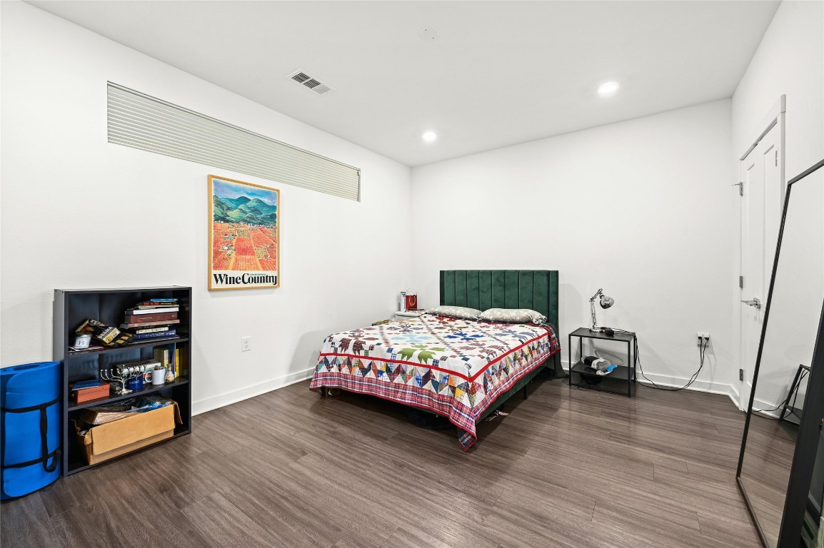 4361 South Congress Avenue, Unit 228 Austin, TX 78745 - Photo 10 of 20 a bedroom with a bed and wooden floor