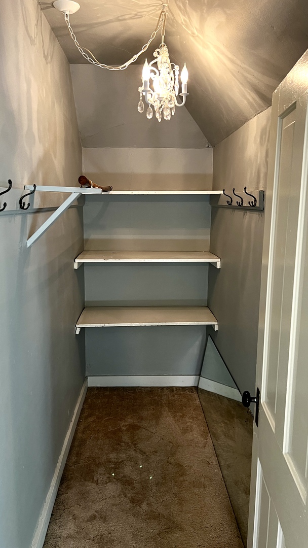 406 South Genesee Street Morrison, IL 61270 - Photo 19 of 34 a view of room with stairs and a chandelier