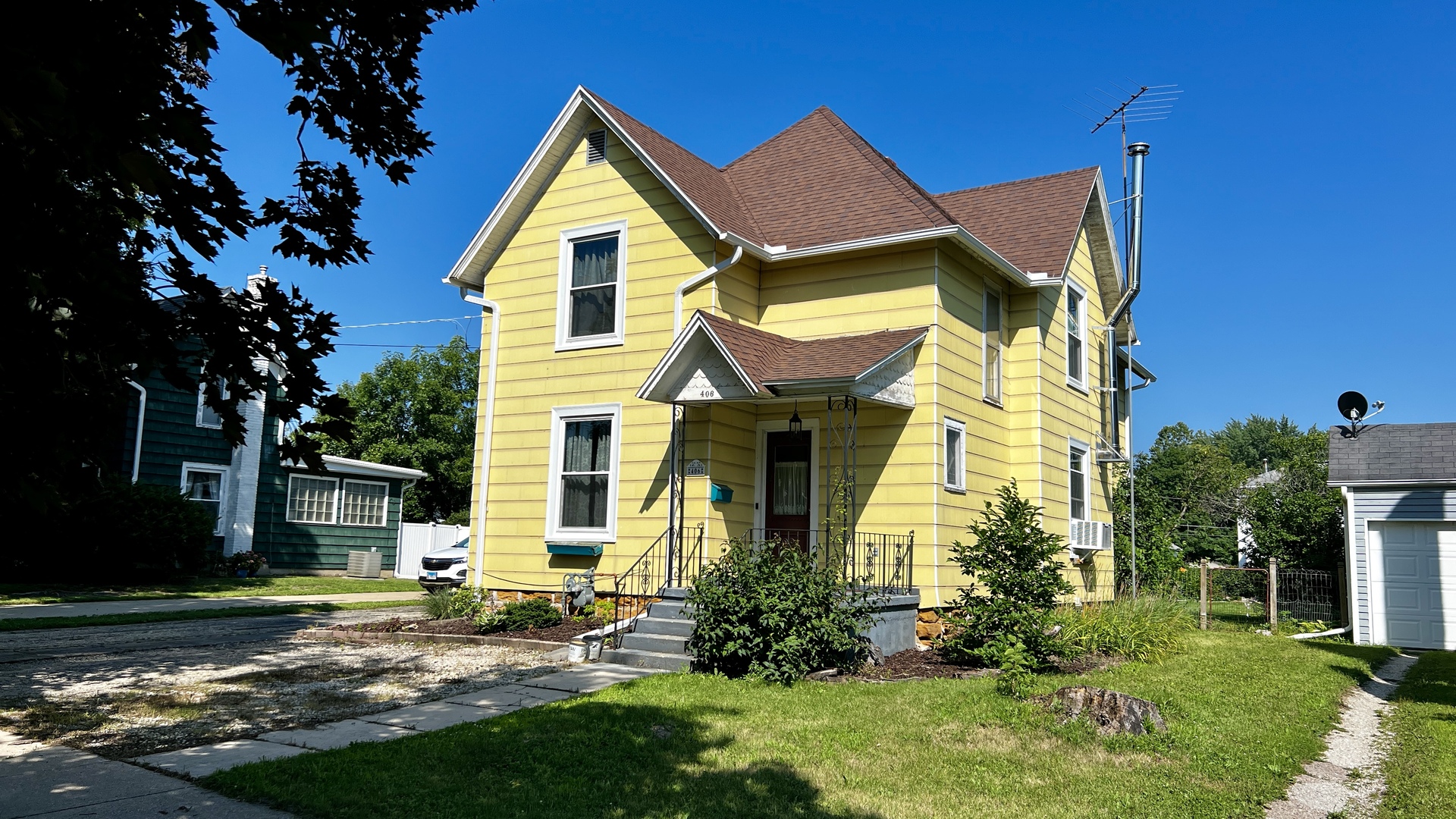 406 South Genesee Street Morrison, IL 61270 - Photo 2 of 34 a view of a house with a small yard and a large tree