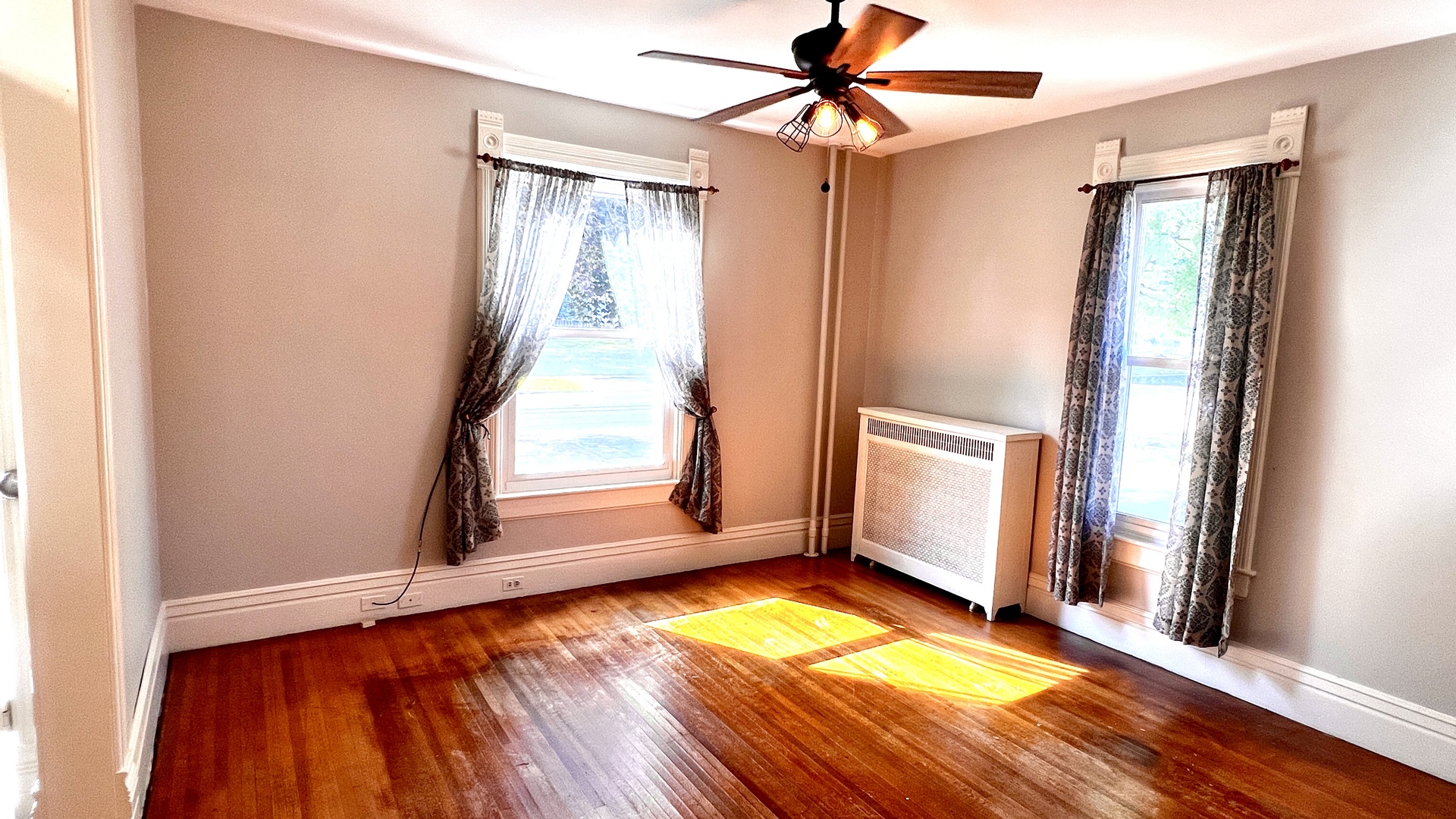 406 South Genesee Street Morrison, IL 61270 - Photo 6 of 34 a view of empty room with wooden floor and fan