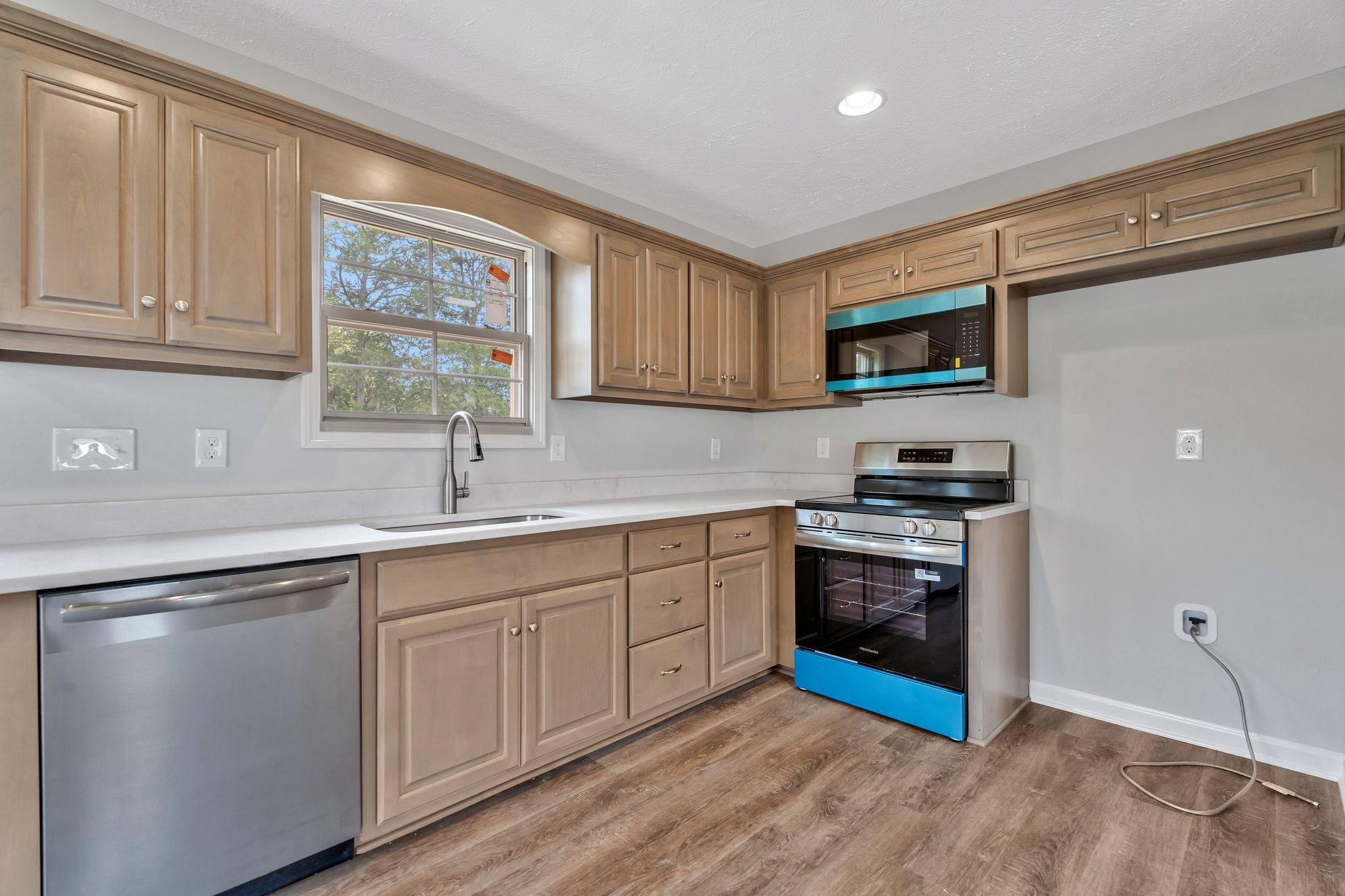383 Doak Road, Unit 40 Manchester, TN 37355 - Photo 12 of 32 a kitchen with stainless steel appliances granite countertop a stove a sink and a microwave