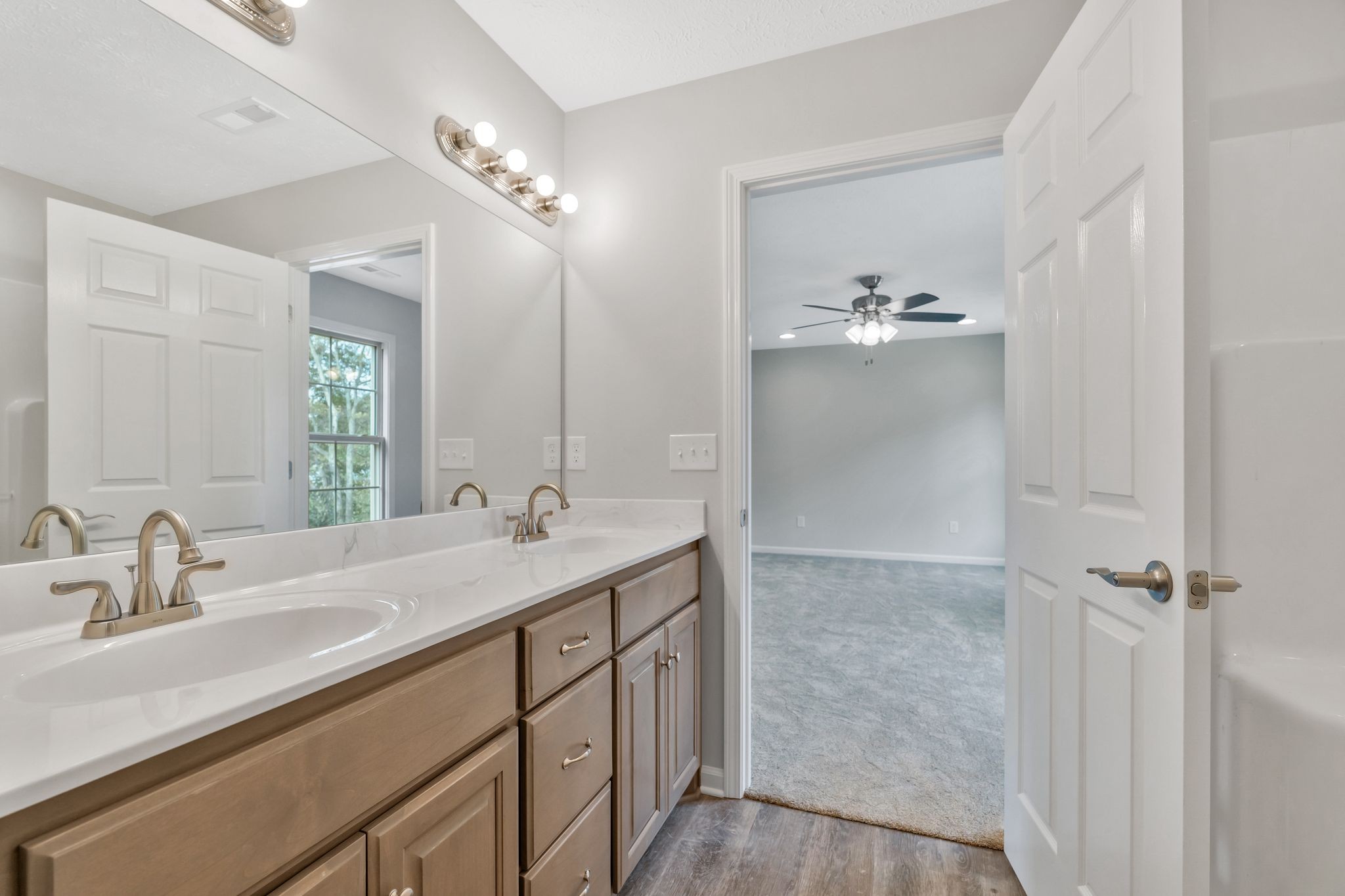 383 Doak Road, Unit 40 Manchester, TN 37355 - Photo 20 of 32 a bathroom with a double vanity sink a mirror and shower