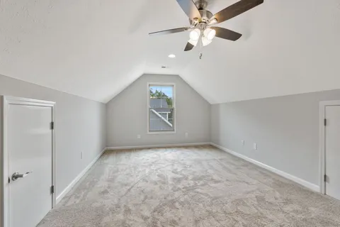 a view of an empty room with a ceiling fan