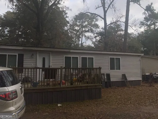 a view of house with backyard and seating area