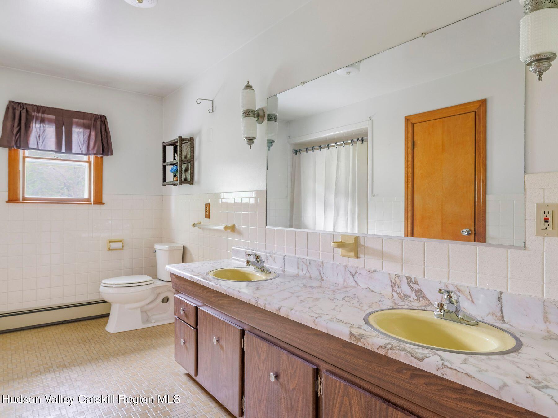 104 New Paltz Road Highland, NY 12528 - Photo 14 of 43 a bathroom with a granite countertop sink and a mirror