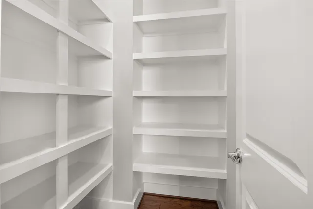 a view of walk in closet with empty racks