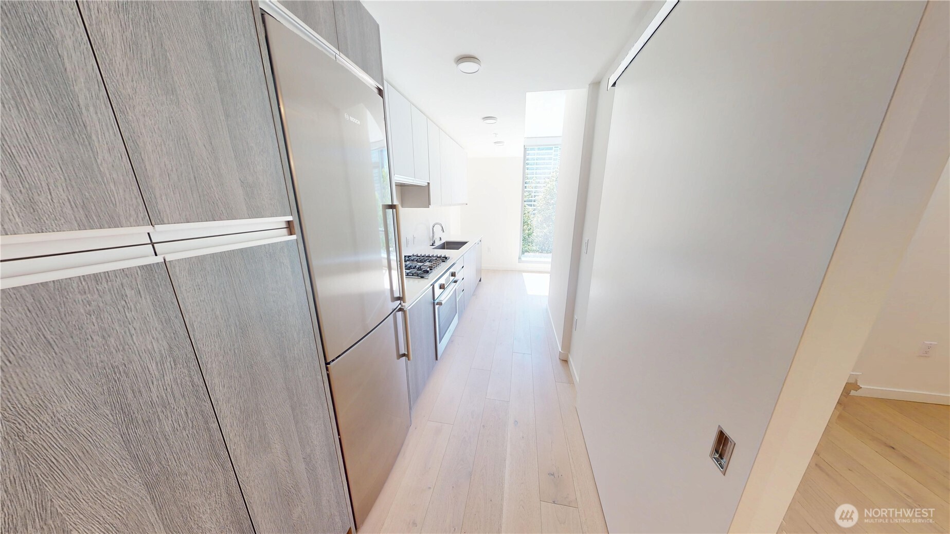 800 Columbia Street, Unit 702 Seattle, WA 98104 - Photo 9 of 15 a view of a livingroom with wooden floor and staircase