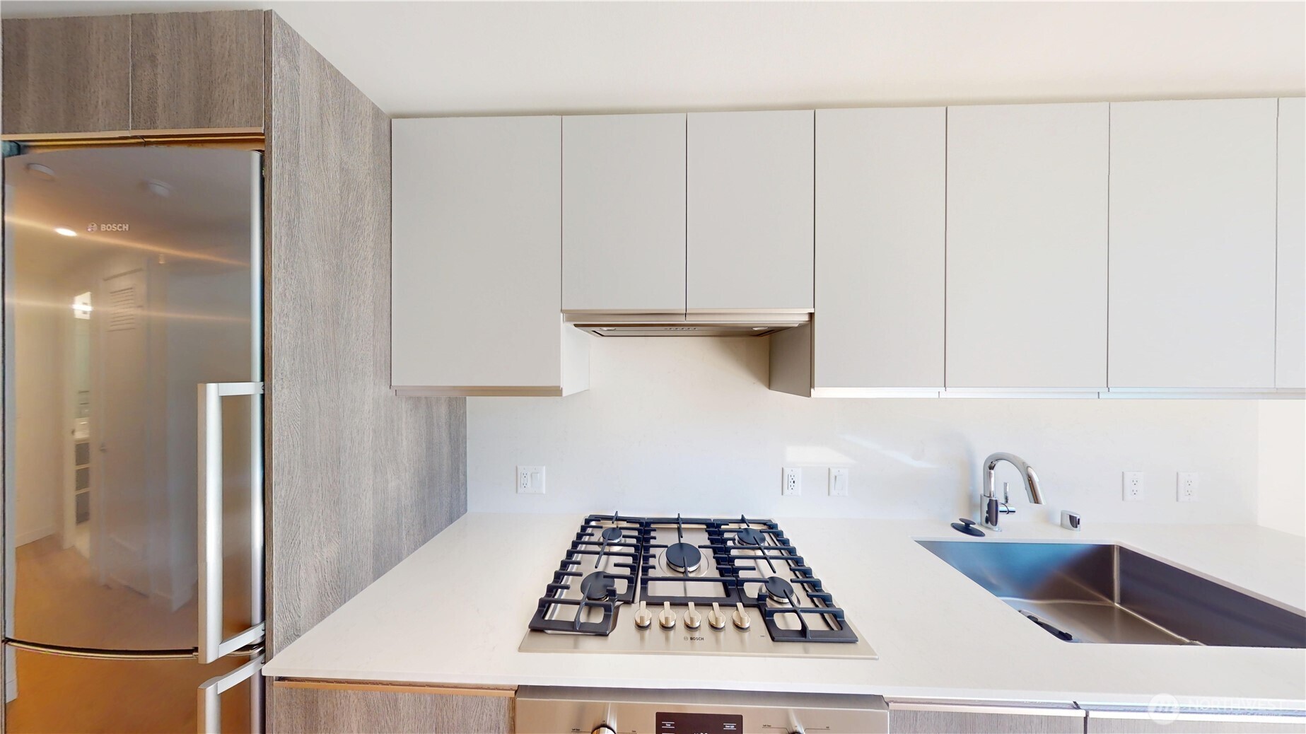 800 Columbia Street, Unit 702 Seattle, WA 98104 - Photo 10 of 15 a kitchen with white cabinets and a stove