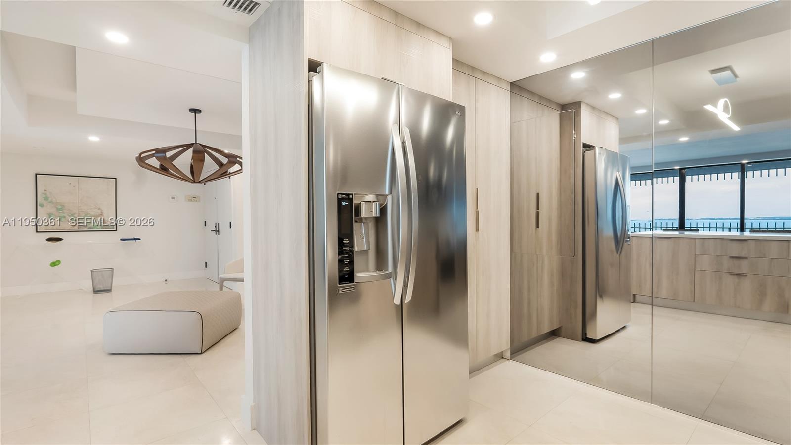 3 Grove Isle Drive, Unit C1407 Miami, FL 33133 - Photo 15 of 45 a bathroom with a tub shower and mirror