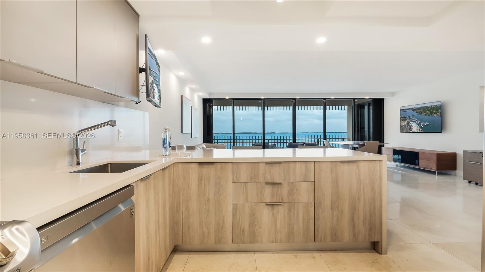 3 Grove Isle Drive, Unit C1407 Miami, FL 33133 - Photo 16 of 45 a large white kitchen with a large window