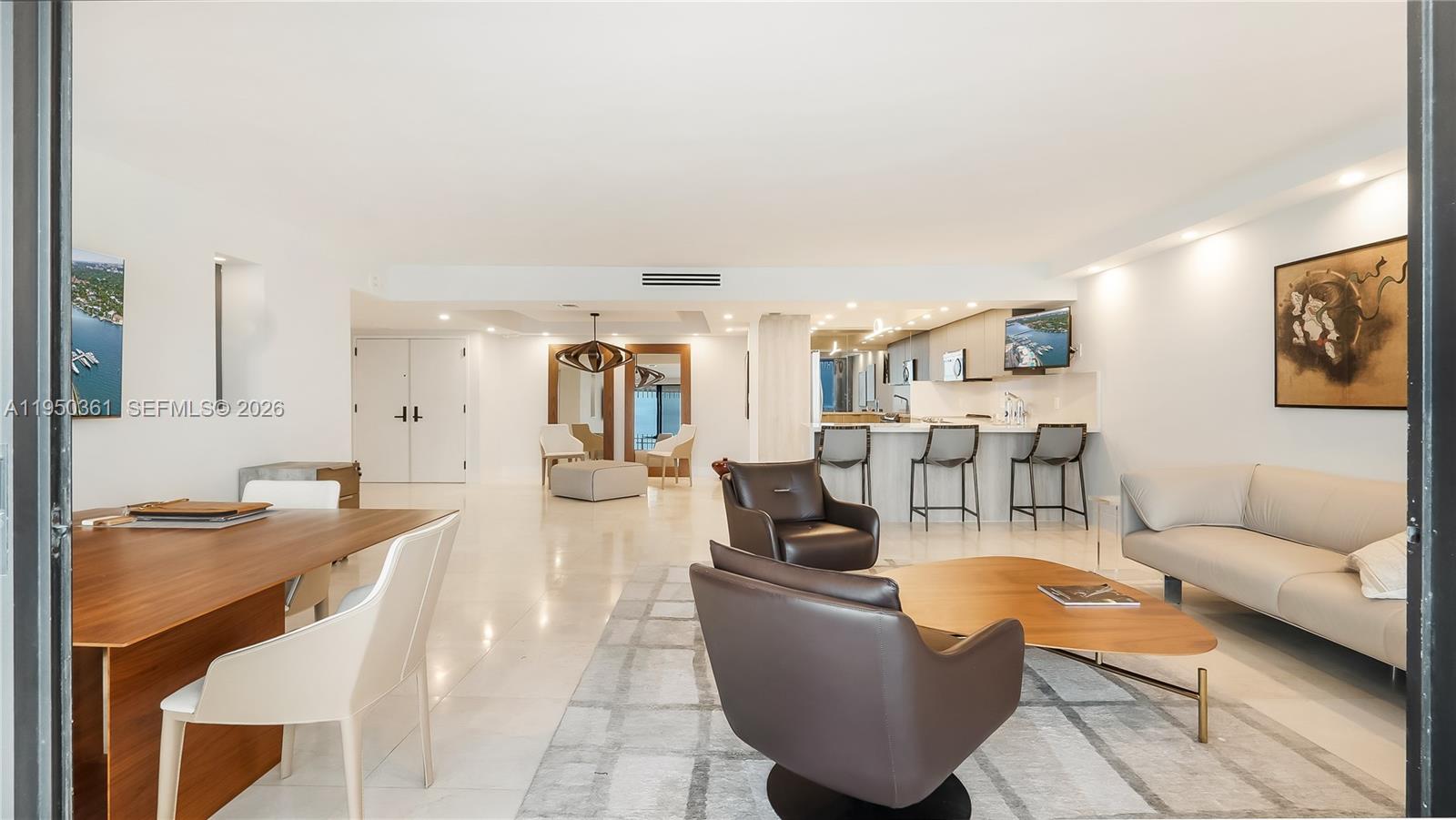 3 Grove Isle Drive, Unit C1407 Miami, FL 33133 - Photo 23 of 45 a living room with furniture and a table