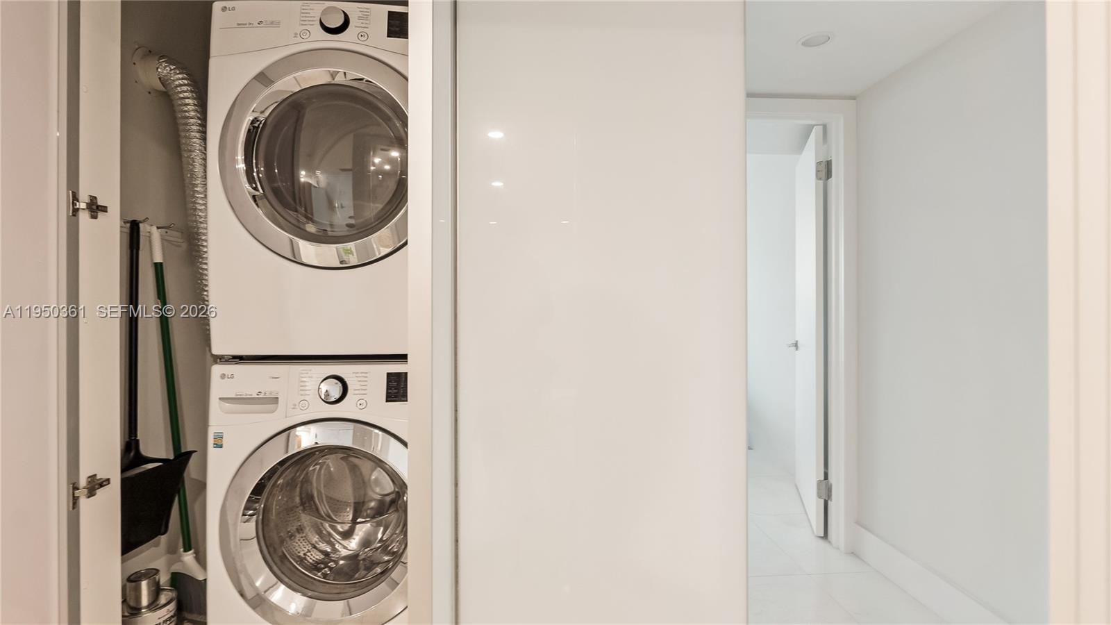 3 Grove Isle Drive, Unit C1407 Miami, FL 33133 - Photo 25 of 45 a utility room with dryer and washer