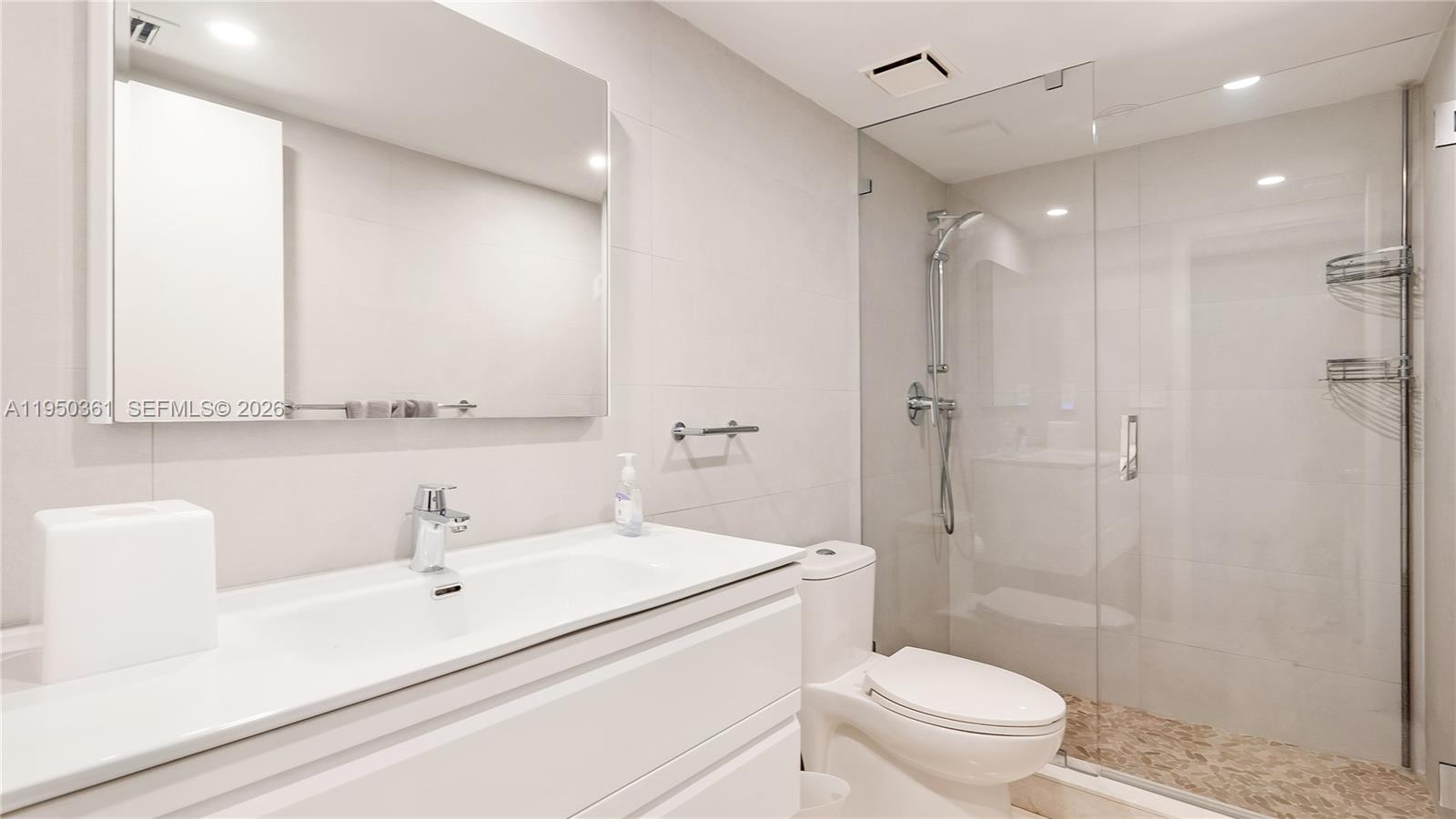 3 Grove Isle Drive, Unit C1407 Miami, FL 33133 - Photo 26 of 45 a bathroom with a sink a toilet and shower