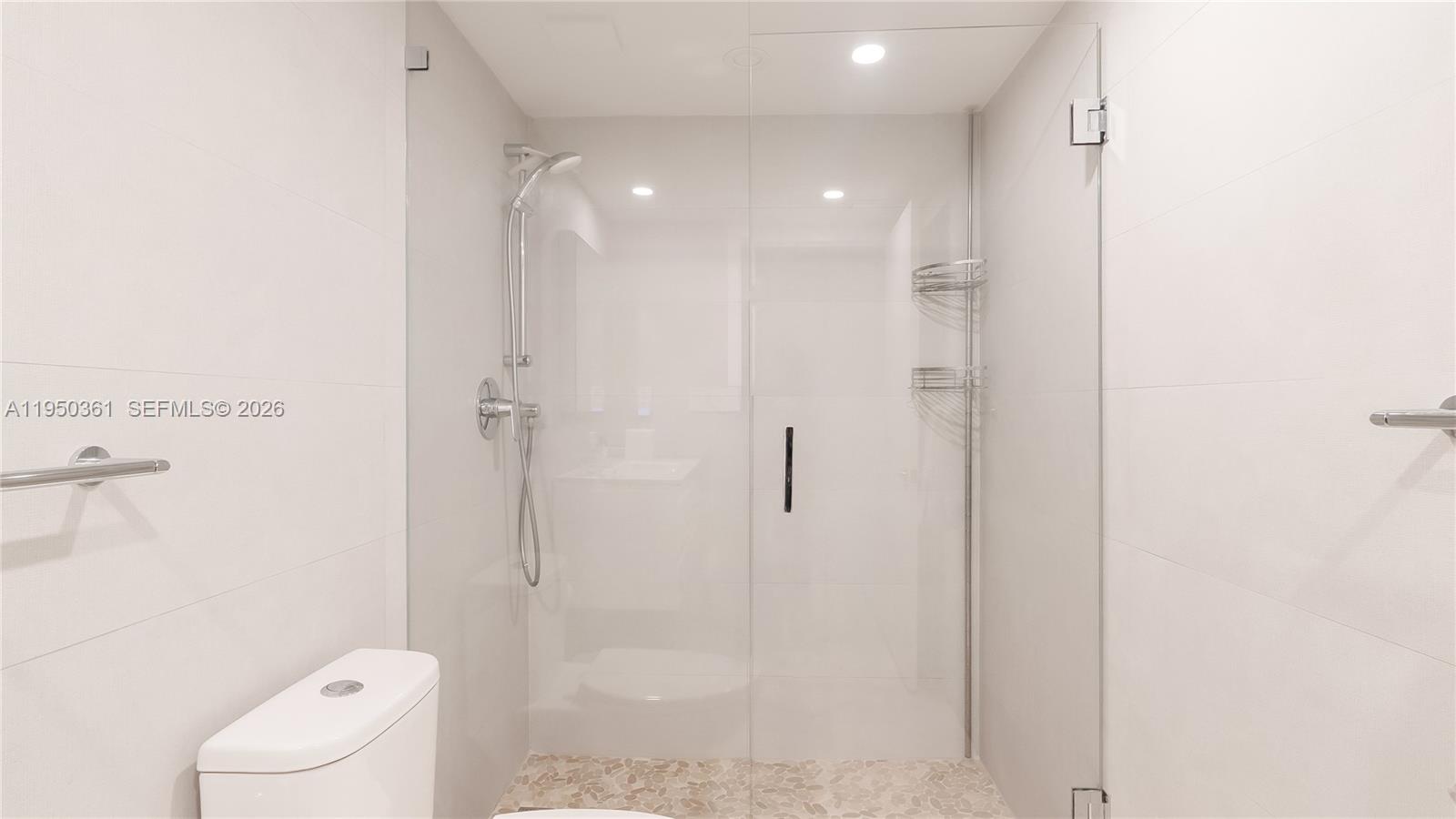 3 Grove Isle Drive, Unit C1407 Miami, FL 33133 - Photo 27 of 45 a bathroom with a shower and toilet