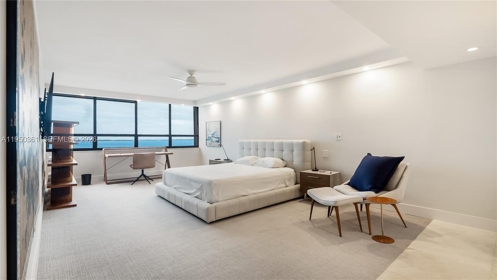 3 Grove Isle Drive, Unit C1407 Miami, FL 33133 - Photo 31 of 45 a spacious bedroom with a bed and large window