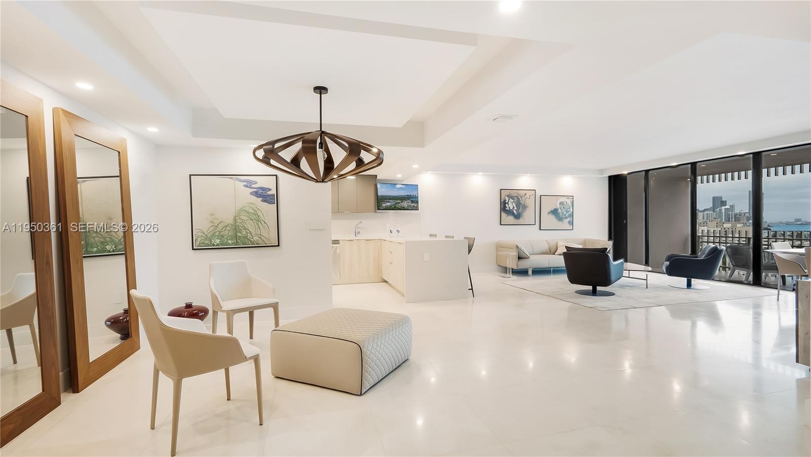 3 Grove Isle Drive, Unit C1407 Miami, FL 33133 - Photo 8 of 45 a living room with furniture and a chandelier