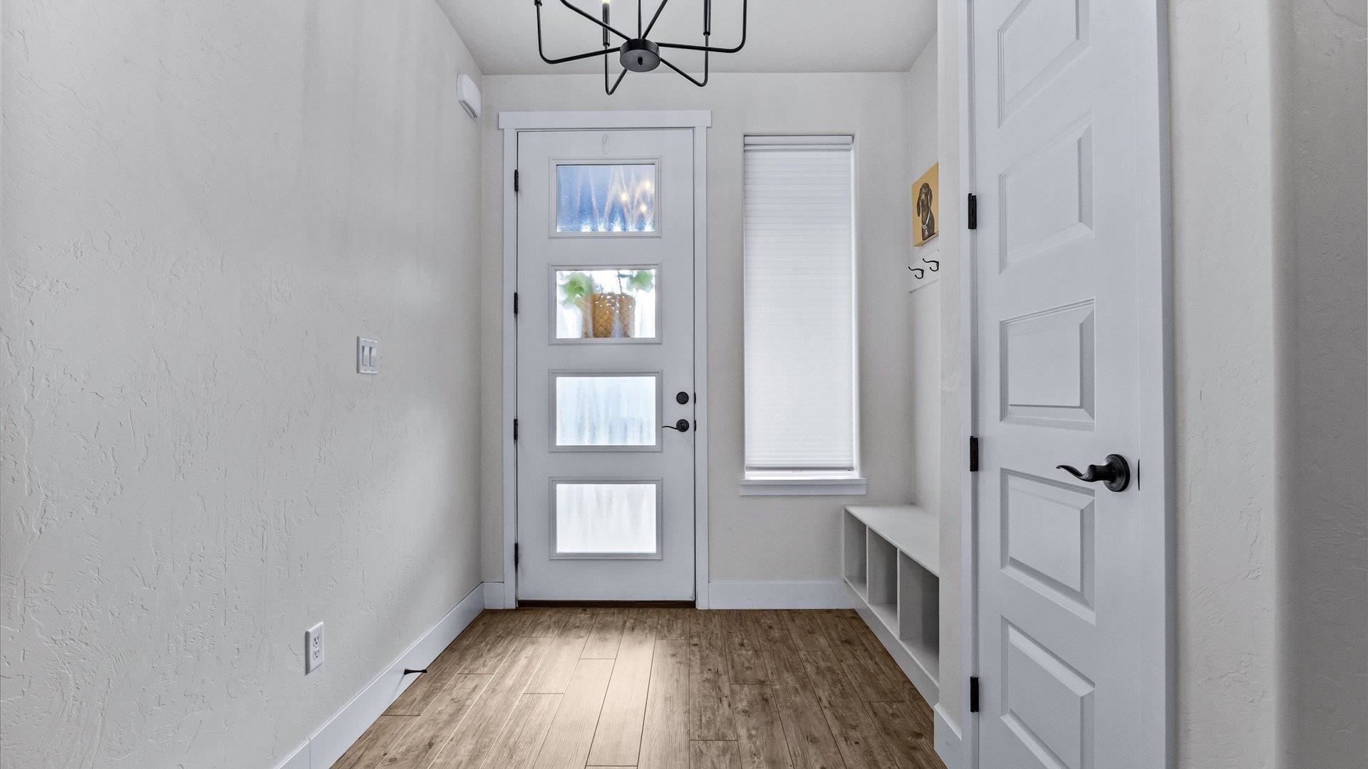 840 Rupp Avenue Palisade, CO 81526 - Photo 5 of 27 a view of a hallway with wooden floor and a bathroom