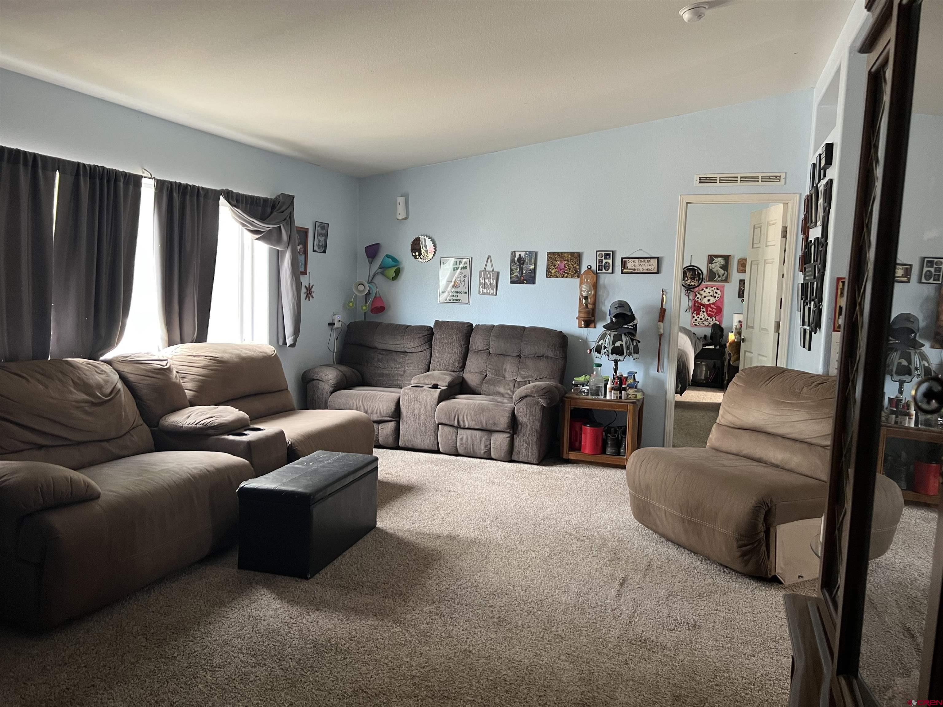 21296 H75 Road Delta, CO 81416 - Photo 8 of 25 a living room with furniture and a flat screen tv